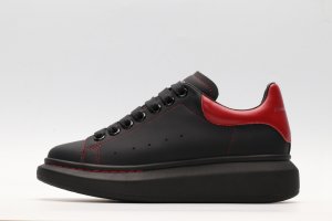 ALEXANDER MCQUEEN black oversized sneakers with red heel
